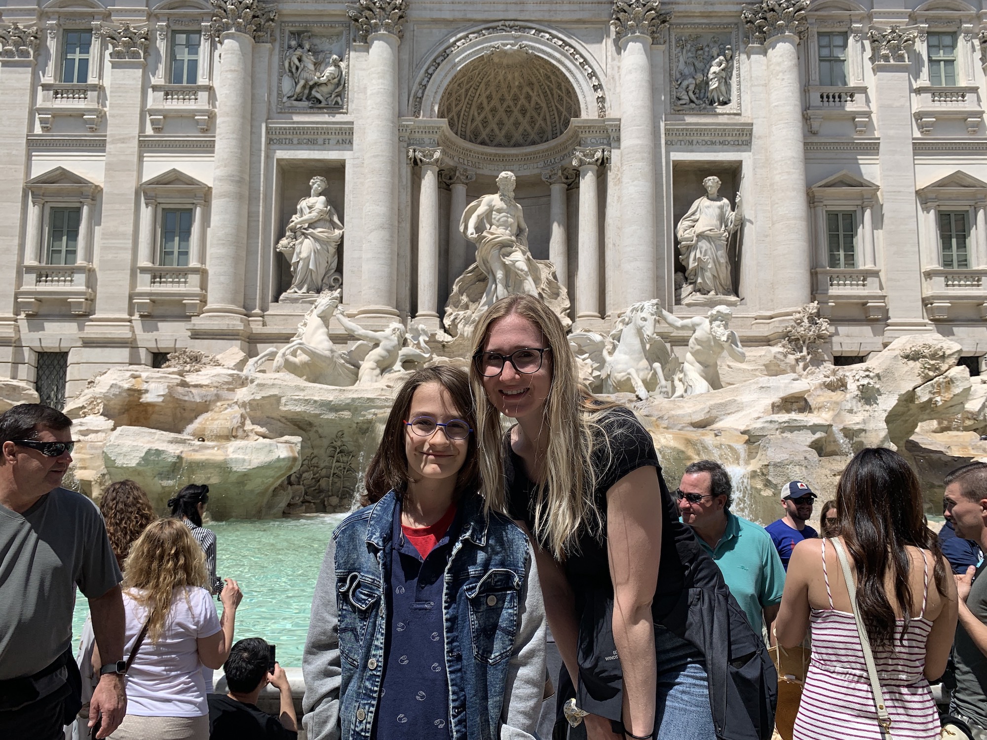 Rome Day Tours image of a family in front of the Trevi Fountain, while touring through the Historical Center